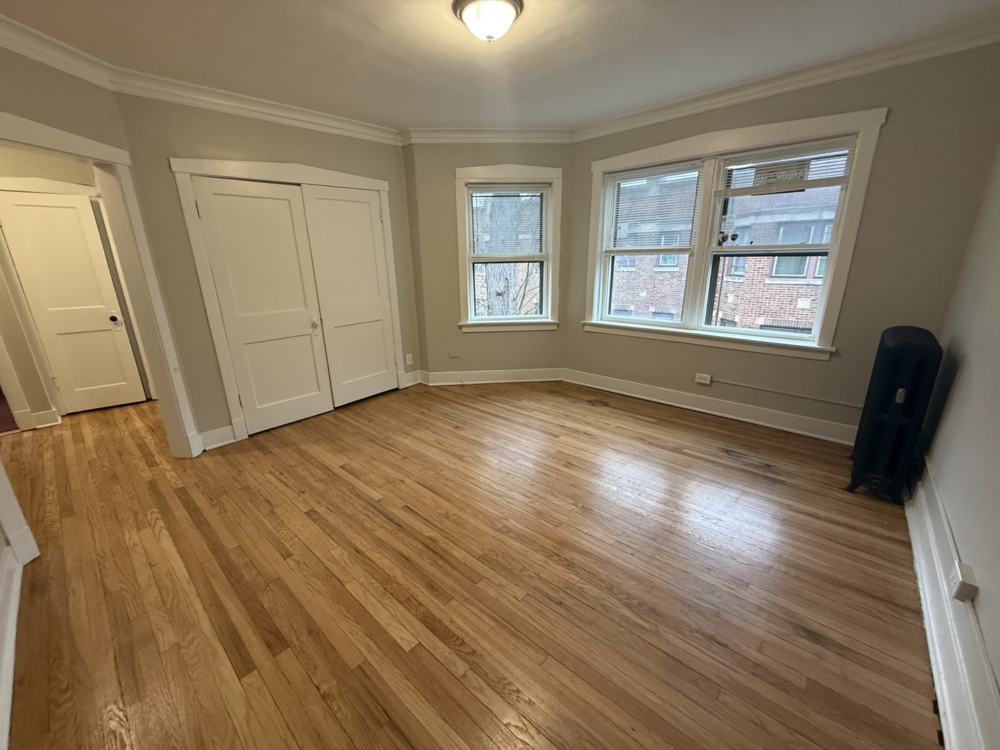 106 Lincoln Avenue, Unit 3W Riverside, IL 60546 - Photo 3 of 10 a view of an empty room with wooden floor and a window