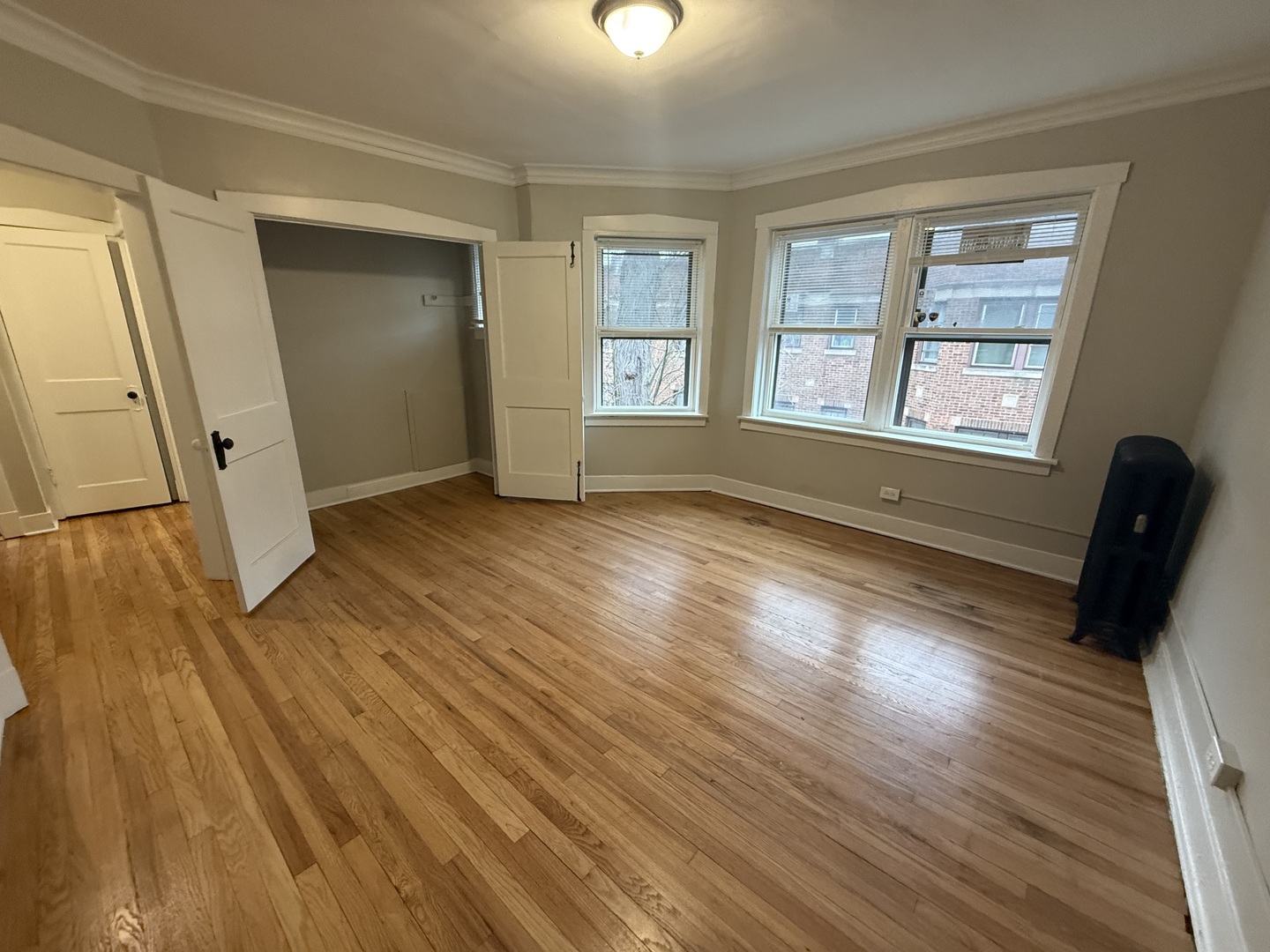 106 Lincoln Avenue, Unit 3W Riverside, IL 60546 - Photo 4 of 10 an empty room with wooden floor and windows