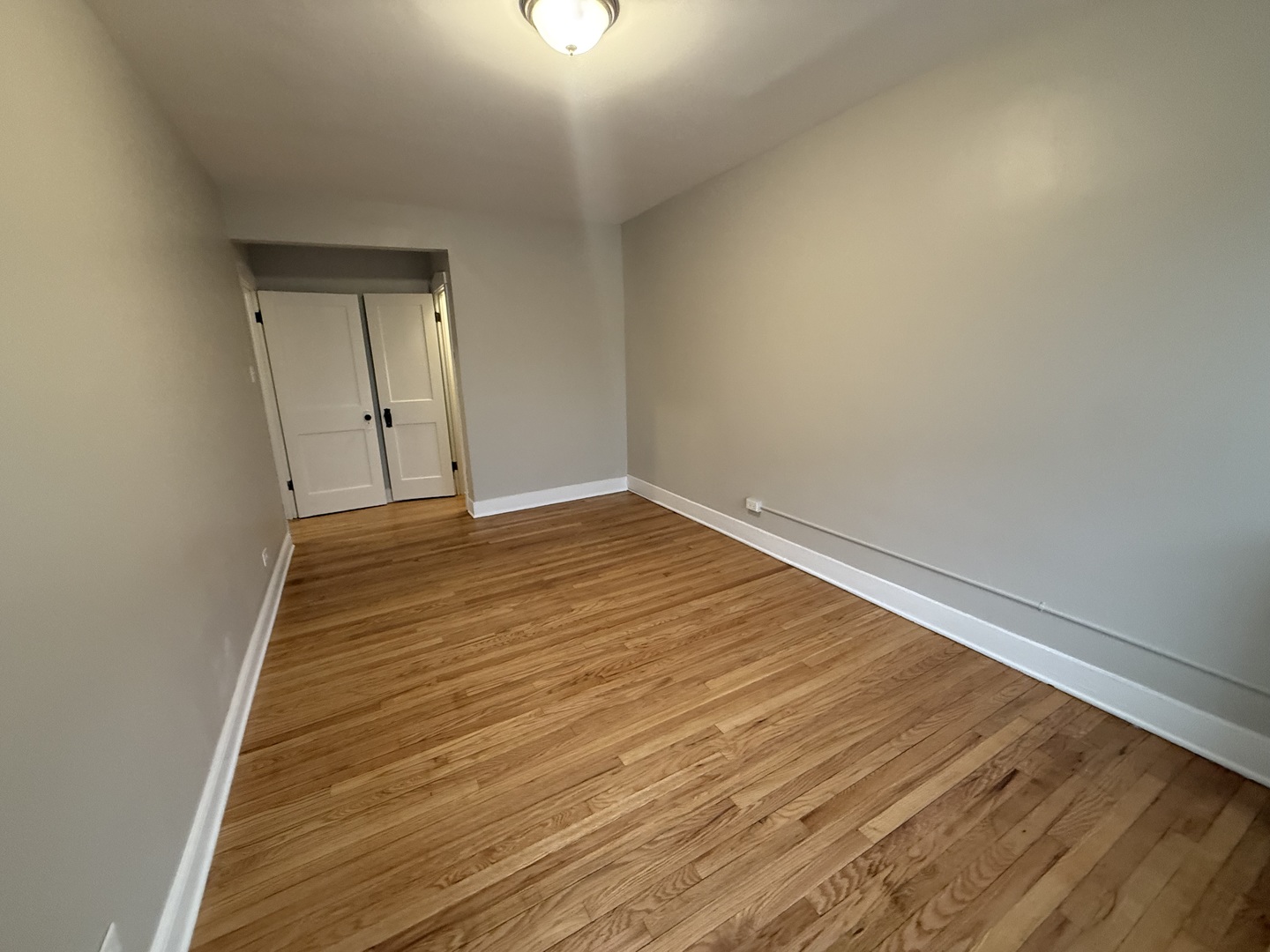 106 Lincoln Avenue, Unit 3W Riverside, IL 60546 - Photo 7 of 10 a view of an empty room with wooden floor