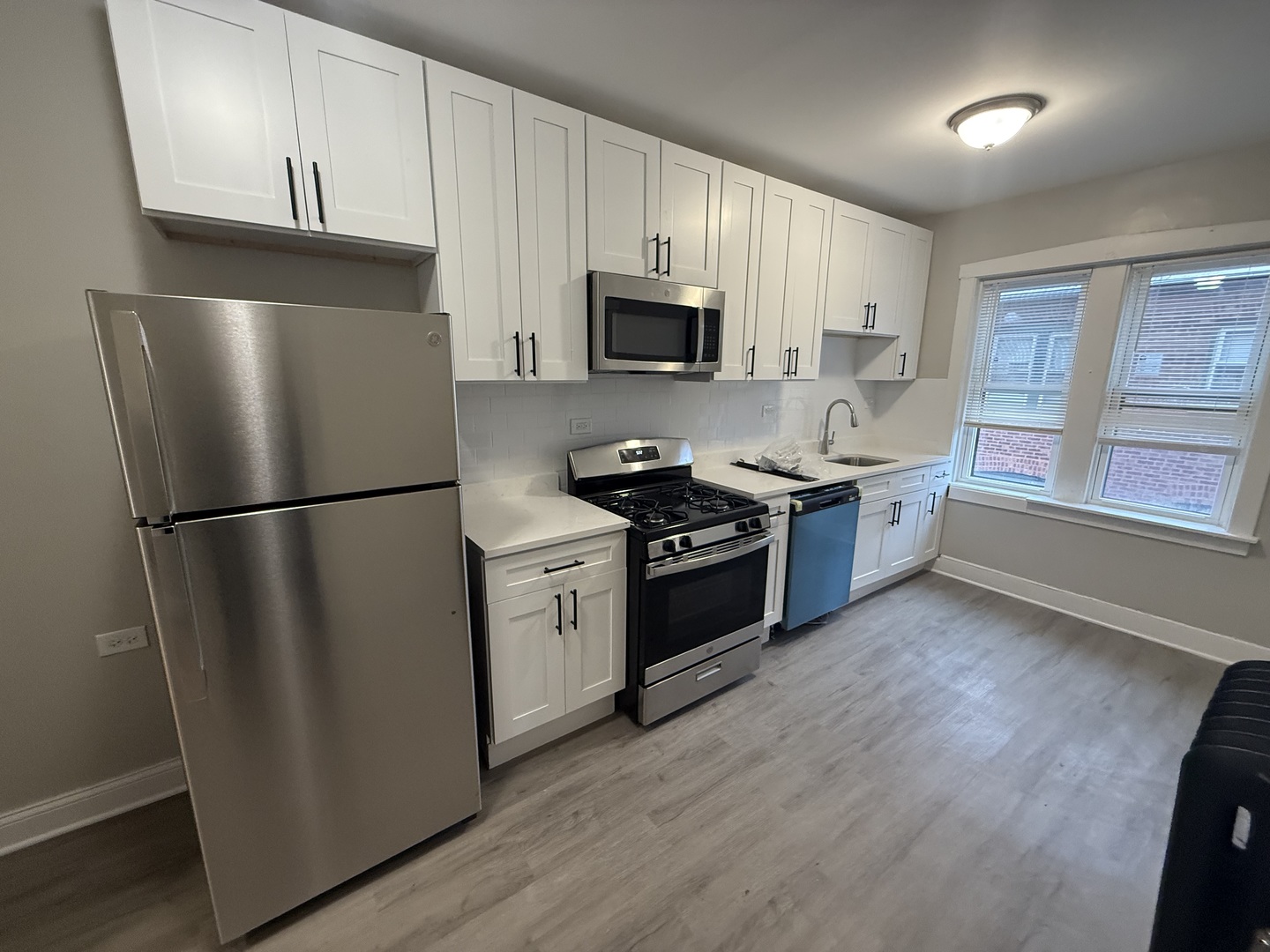 106 Lincoln Avenue, Unit 3W Riverside, IL 60546 - Photo 8 of 10 a kitchen with stainless steel appliances granite countertop a refrigerator stove a sink and a microwave