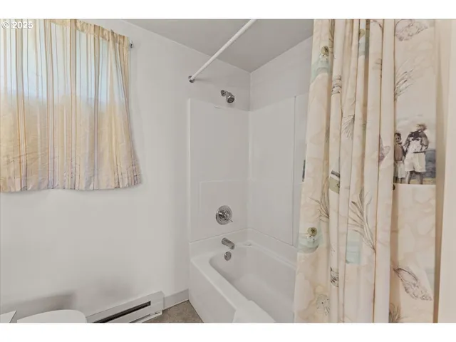 a bathroom with a shower curtain and a sink