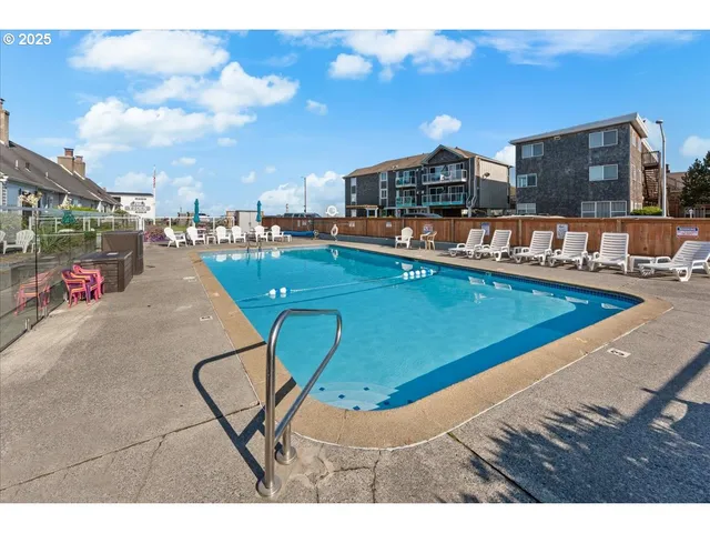 a view of a swimming pool with lounge chair