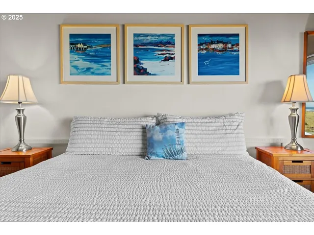 a bedroom with a bed and painting on the wall