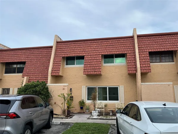 a front view of a house with parking space