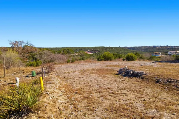 a view of a yard with wooden fence