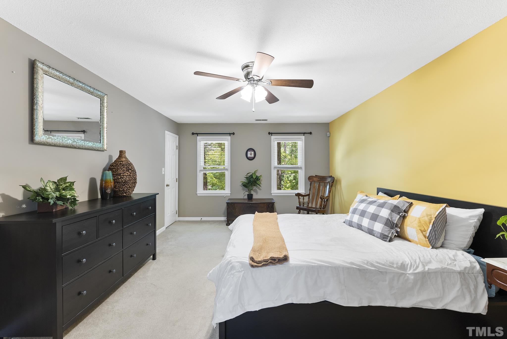 4205 Pleasant Grove Church Road Raleigh, NC 27613 - Photo 14 of 34 a bedroom with a bed and a chandelier
