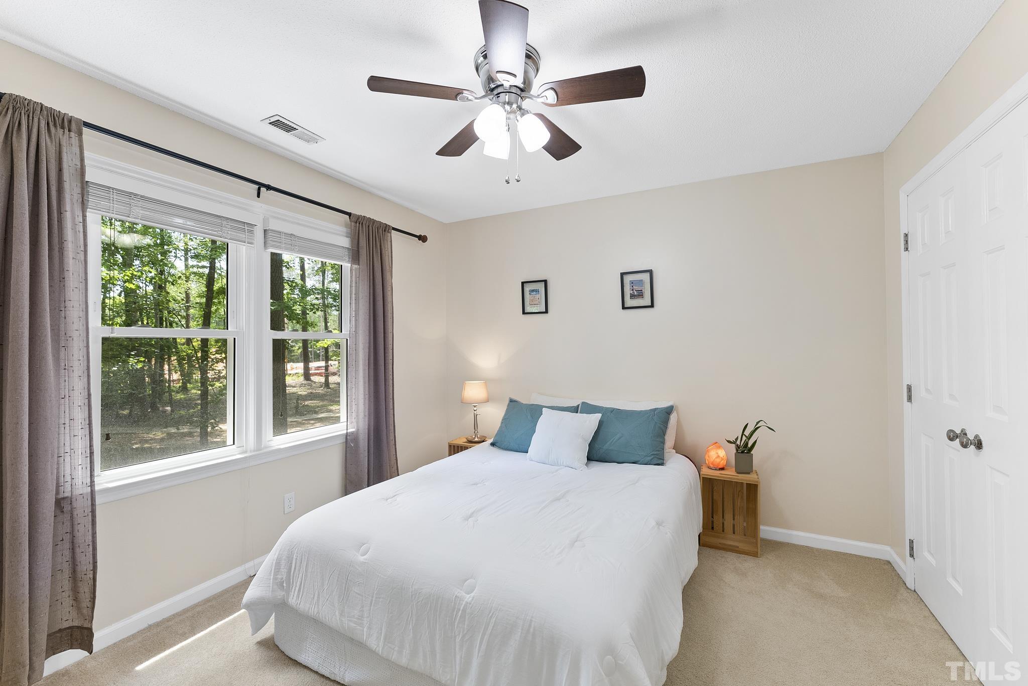 4205 Pleasant Grove Church Road Raleigh, NC 27613 - Photo 18 of 34 a bedroom with a large bed and a window