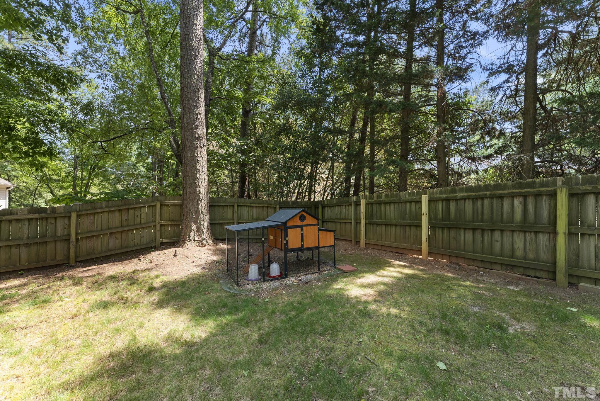 4205 Pleasant Grove Church Road Raleigh, NC 27613 - Photo 29 of 34 a view of a backyard with wooden fence and a bench