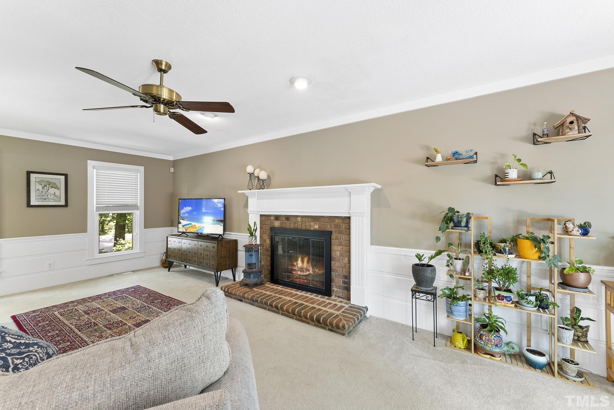 4205 Pleasant Grove Church Road Raleigh, NC 27613 - Photo 4 of 34 a living room with furniture and a fireplace
