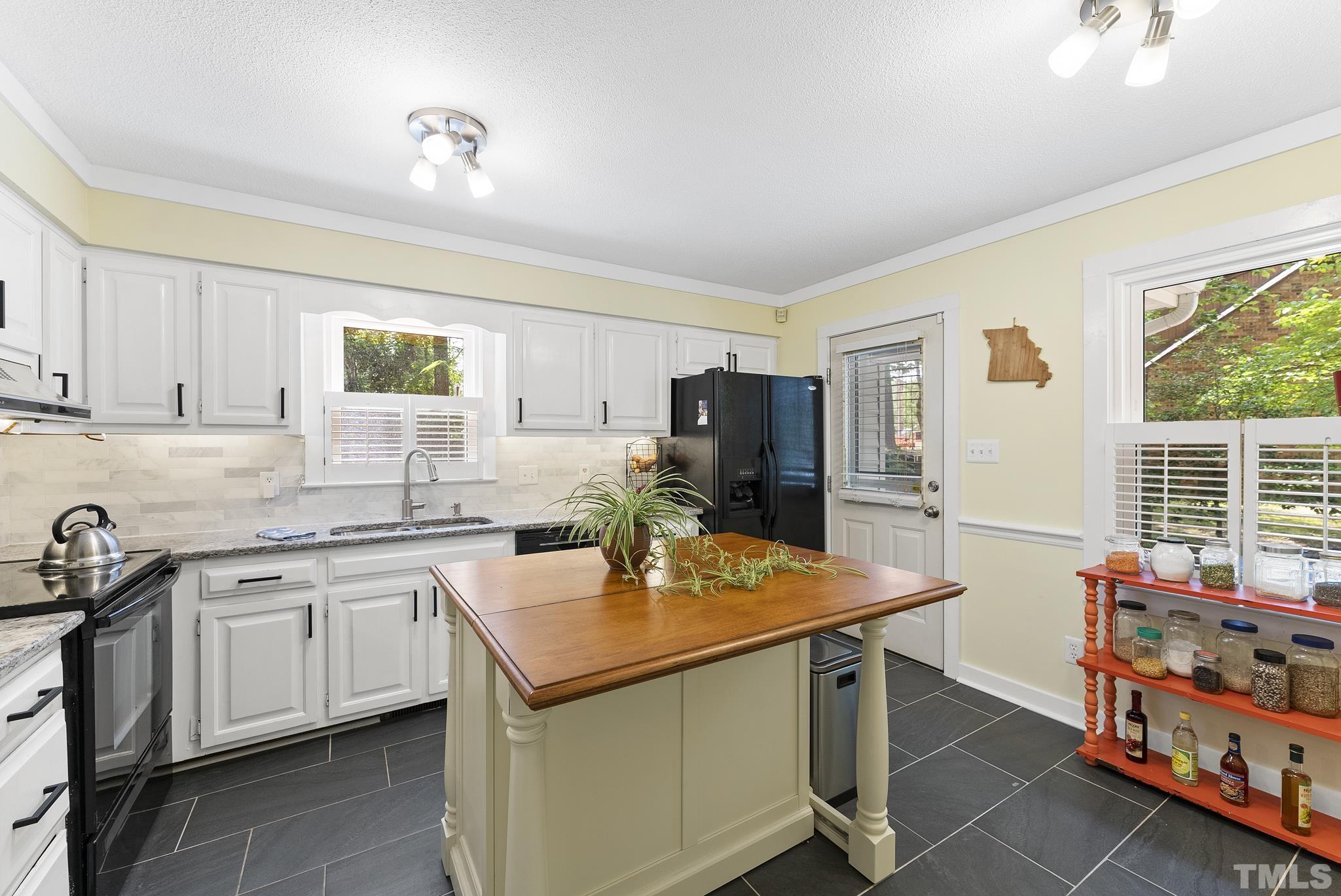 4205 Pleasant Grove Church Road Raleigh, NC 27613 - Photo 7 of 34 a kitchen with stainless steel appliances granite countertop a sink stove and refrigerator