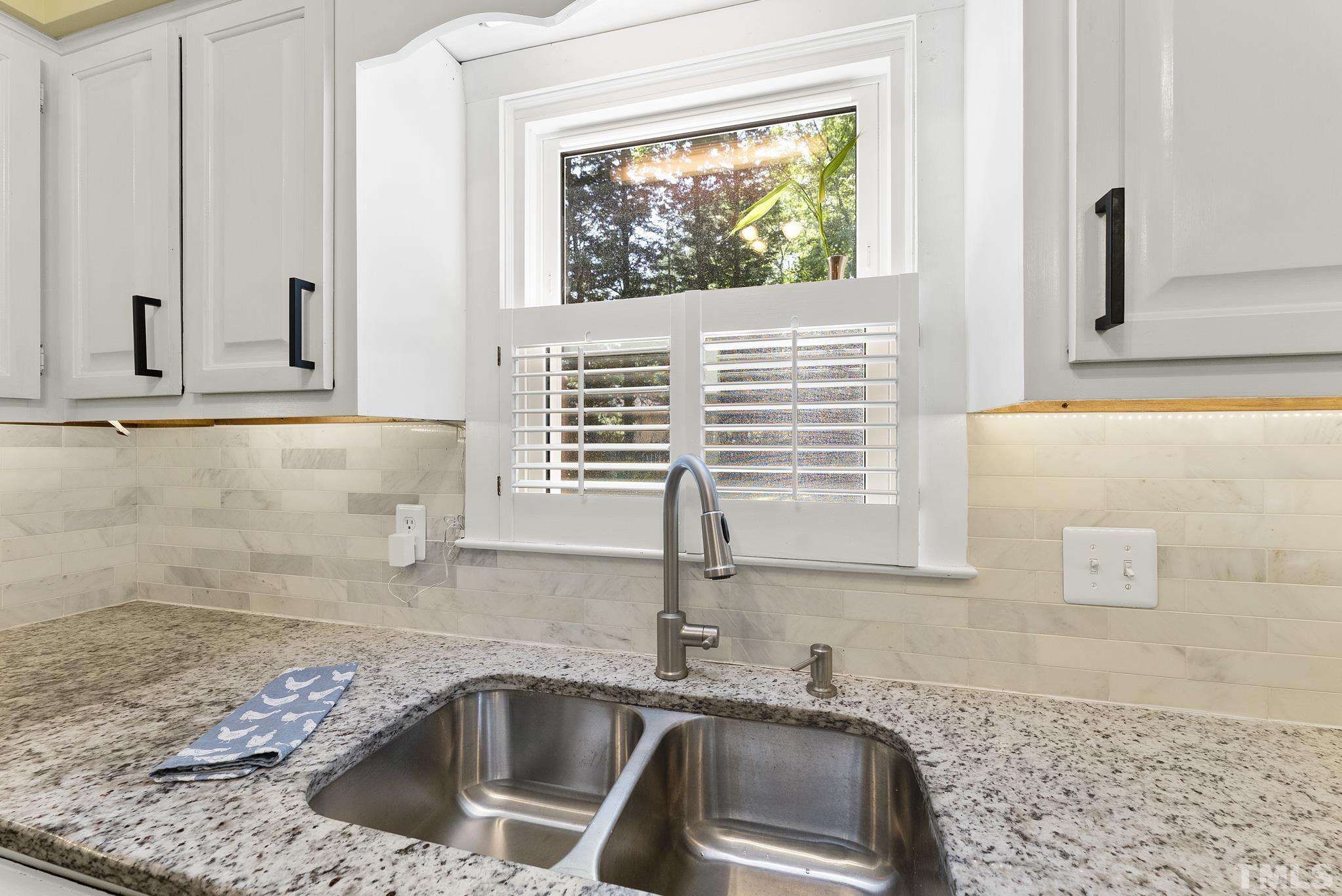 4205 Pleasant Grove Church Road Raleigh, NC 27613 - Photo 9 of 34 a kitchen with granite countertop a sink and a window