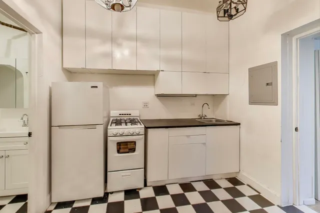 a white refrigerator freezer sitting inside of a kitchen