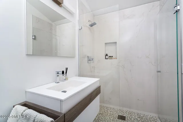 a bathroom with a sink a light fixture and a mirror