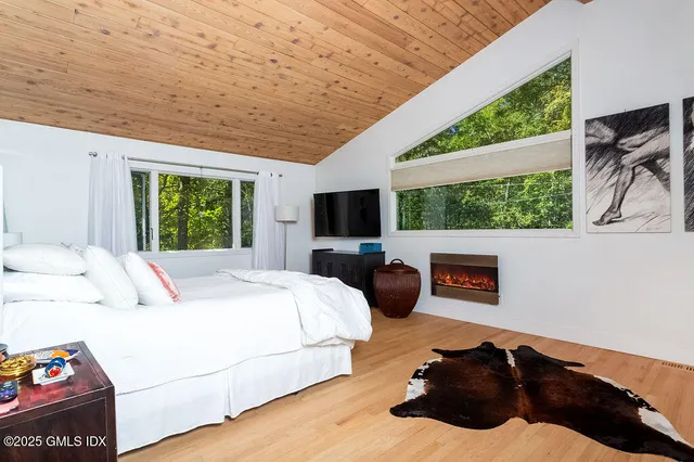 a living room with furniture tv and a large window
