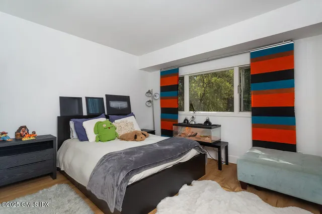 a bedroom with a bed and balcony