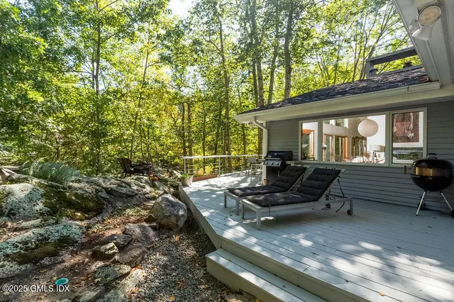 a view of a backyard with sitting area