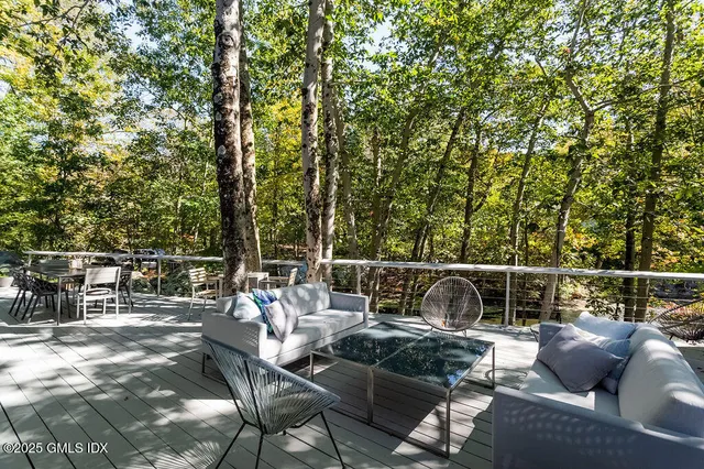 a terrace with outdoor seating and trees