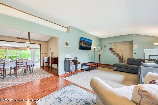 a living room with furniture and a floor to ceiling window
