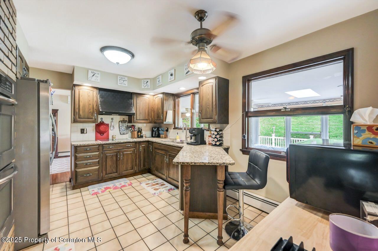 2352 Newton Ransom Boulevard Clarks Summit, PA 18411 - Photo 17 of 85 a kitchen with granite countertop a sink appliances cabinets and furniture
