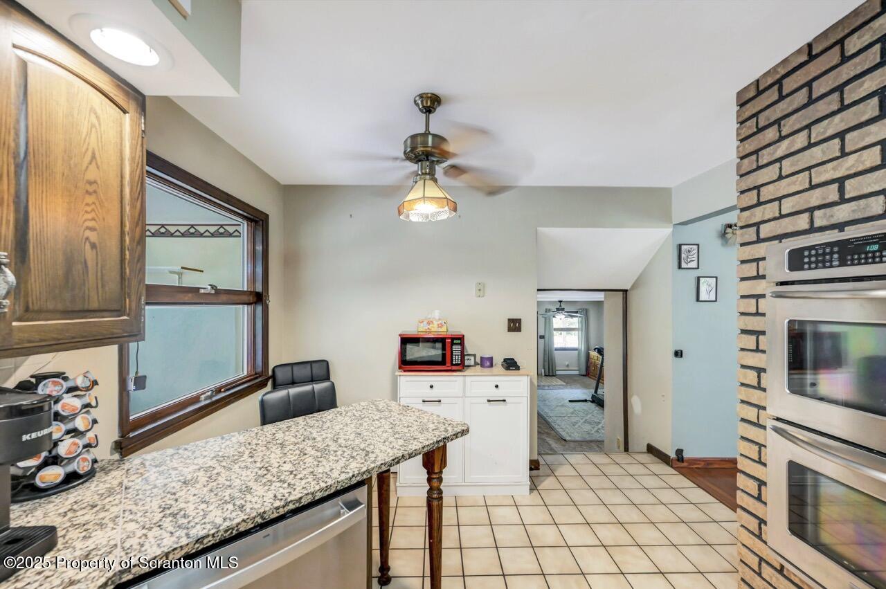 2352 Newton Ransom Boulevard Clarks Summit, PA 18411 - Photo 20 of 85 a kitchen with stainless steel appliances granite countertop a sink dishwasher stove and refrigerator