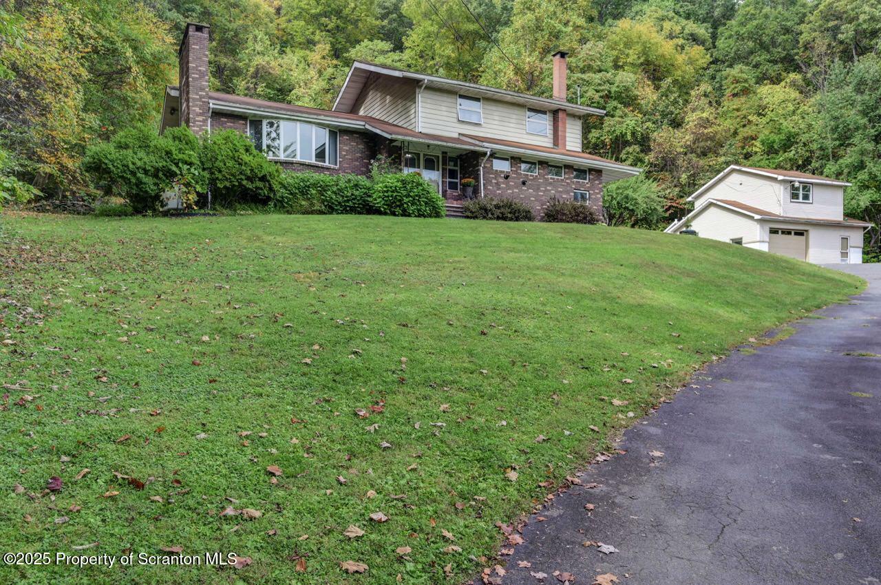 2352 Newton Ransom Boulevard Clarks Summit, PA 18411 - Photo 2 of 85 a view of a house next to a big yard and large trees