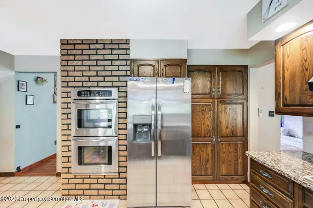 a spacious bathroom with a double vanity sink a mirror and next to a window