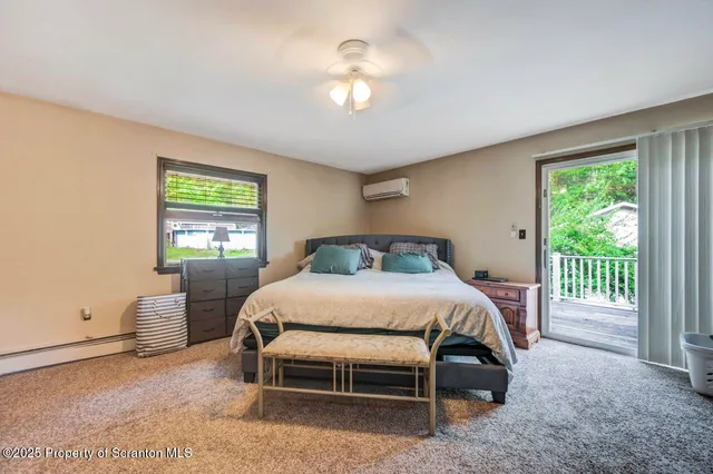 a bedroom with two beds and window