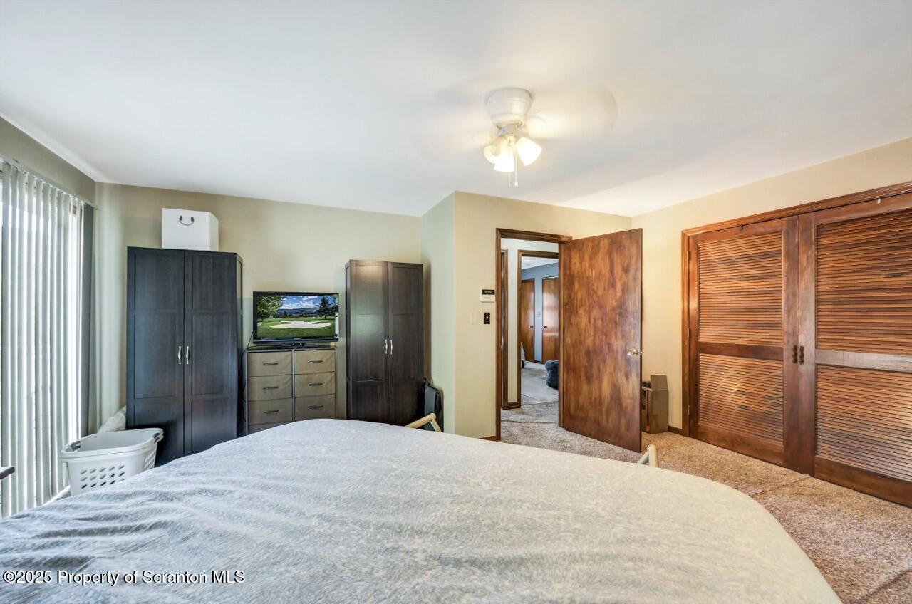 2352 Newton Ransom Boulevard Clarks Summit, PA 18411 - Photo 26 of 85 a bedroom with a bed and a chandelier