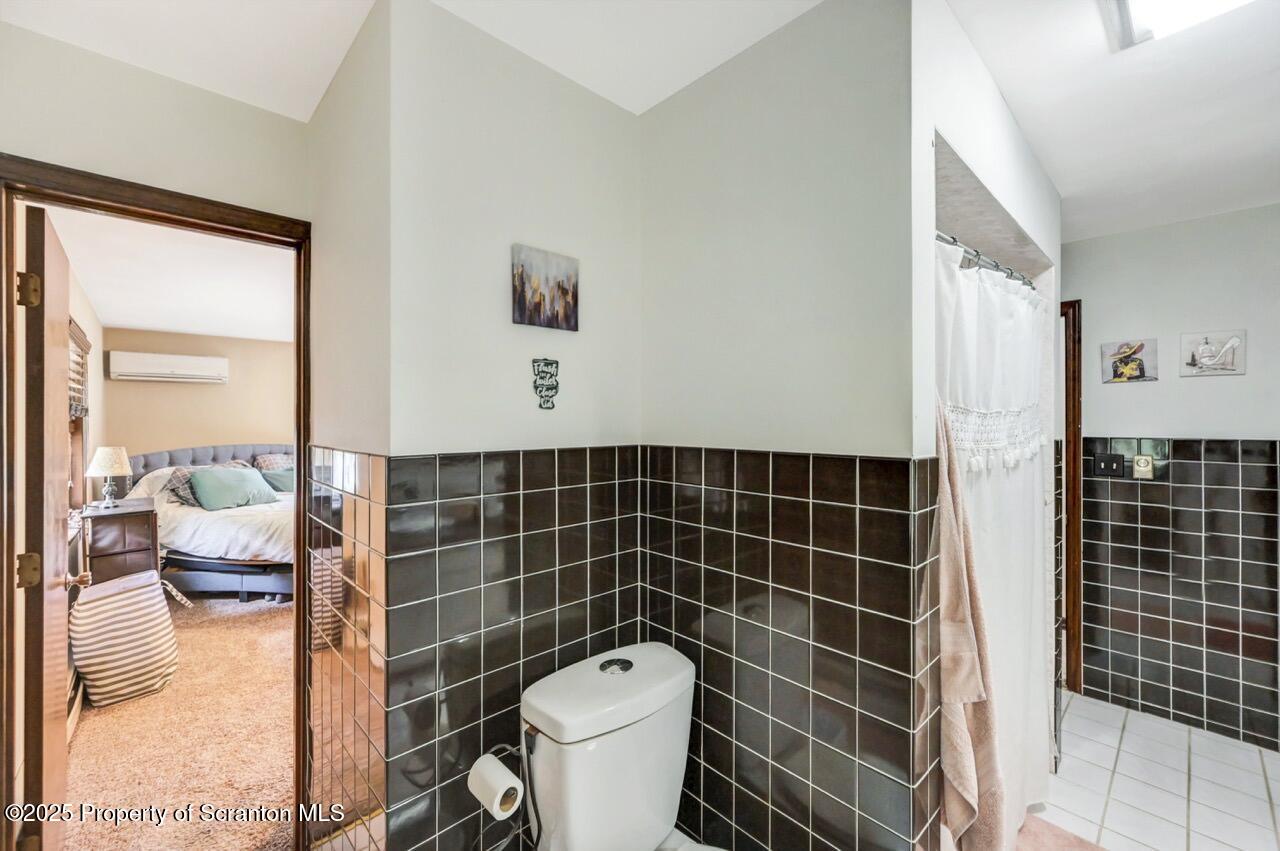 2352 Newton Ransom Boulevard Clarks Summit, PA 18411 - Photo 30 of 85 a bathroom with a toilet a sink and shower