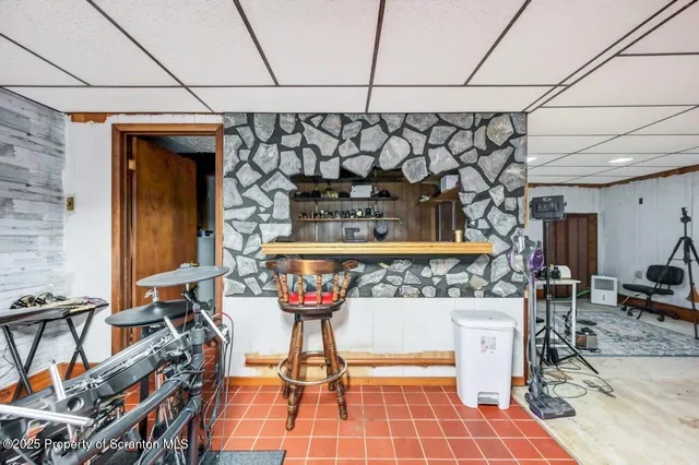 a kitchen with a stove a sink a dining table and chairs