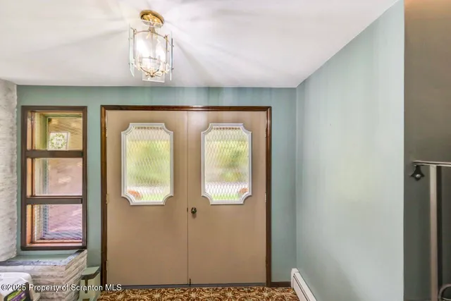 a kitchen with granite countertop a stove and white cabinets