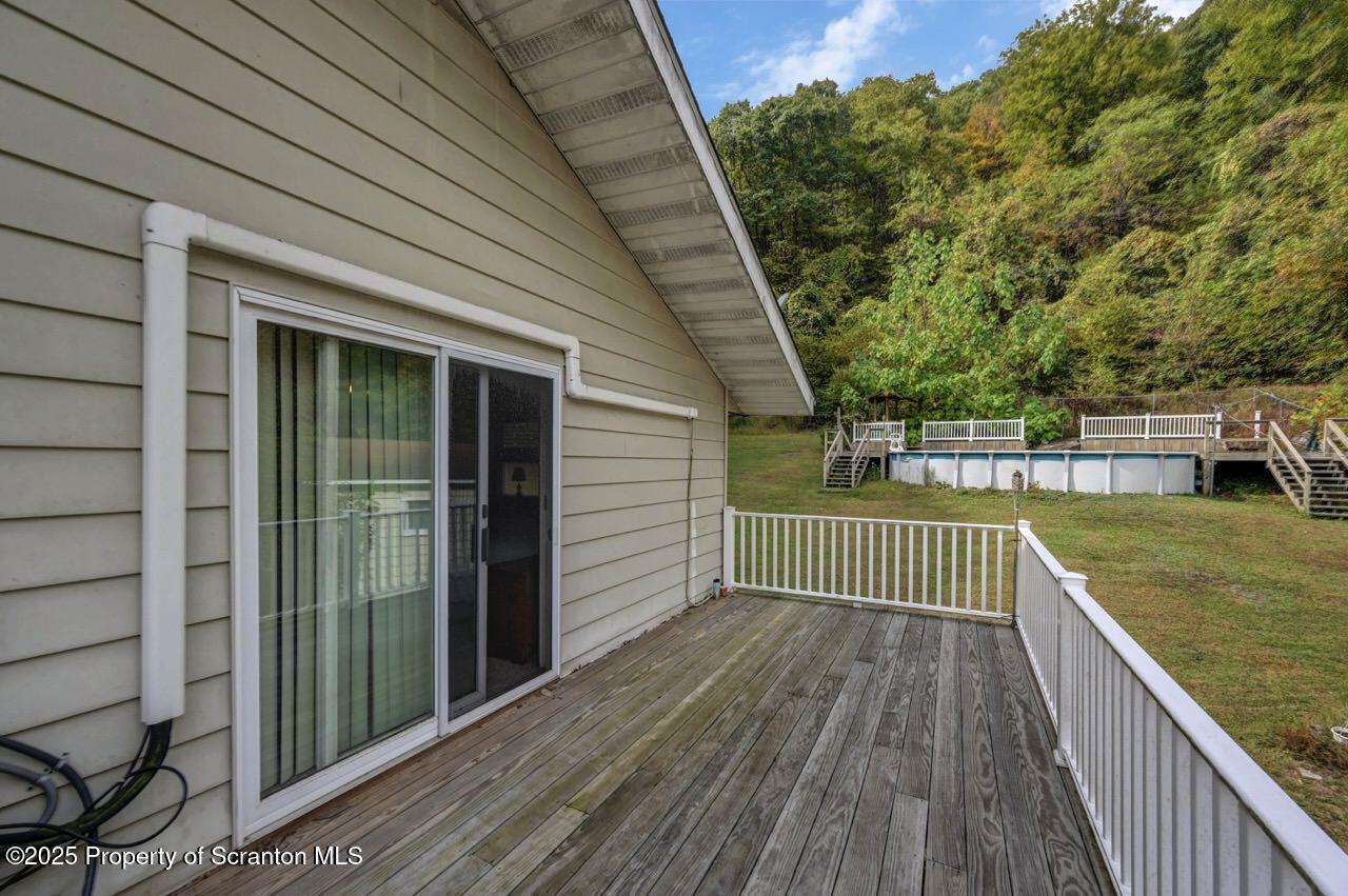 2352 Newton Ransom Boulevard Clarks Summit, PA 18411 - Photo 83 of 85 a view of deck with wooden floor and fence and a floor to ceiling window