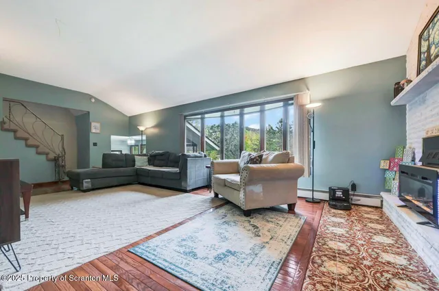 a living room with furniture and a floor to ceiling window