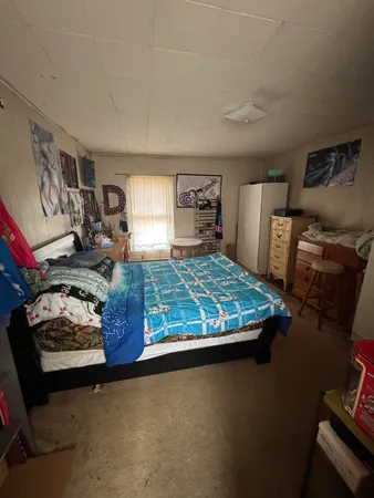a bedroom with furniture and flat screen tv