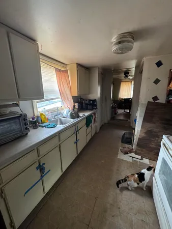 a kitchen with a sink appliances and a counter top space