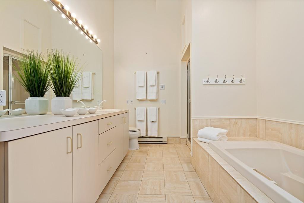 11 Clovelly Road Newton, MA 02467 - Photo 23 of 25 a bathroom with a granite countertop sink a toilet a mirror and bathtub