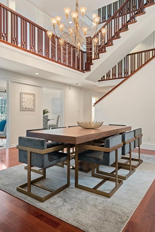 11 Clovelly Road Newton, MA 02467 - Photo 8 of 25 a view of a hall with wooden floor and a dining table chairs