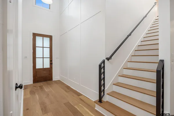 a view of entryway with wooden floor and stairs