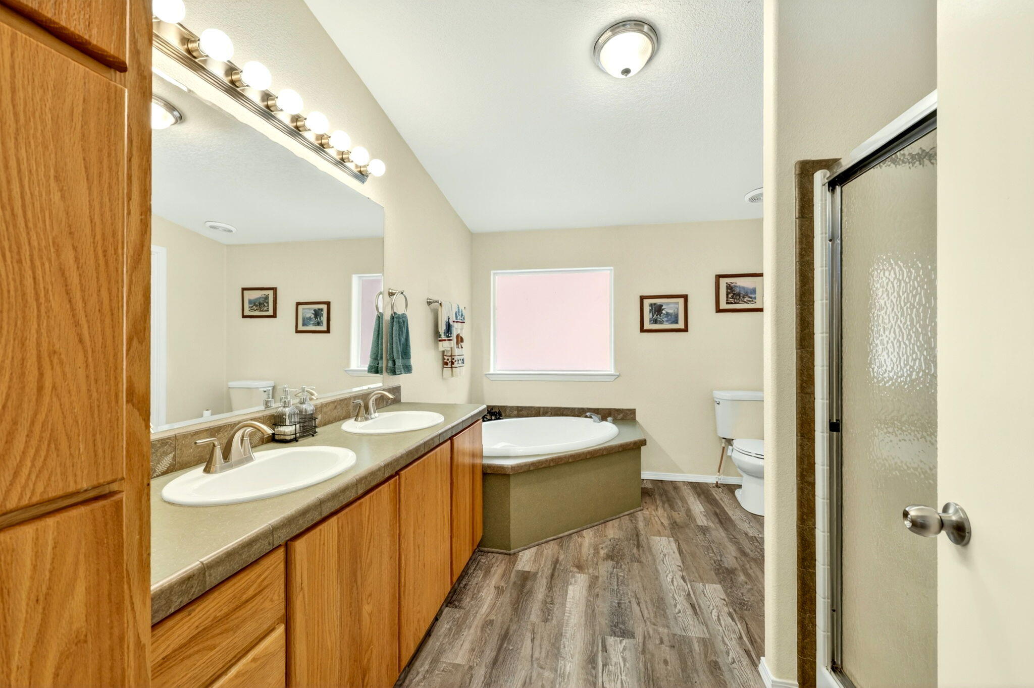 5445 Thompson Creek Road Selma, OR 97538 - Photo 28 of 57 a spacious bathroom with a double vanity sink and a mirror