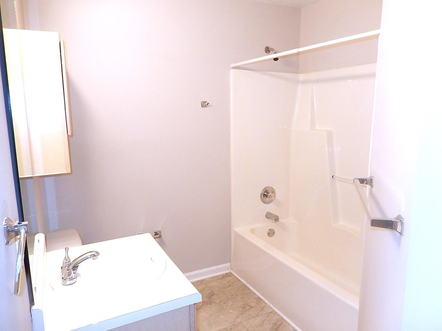 211 Bridgepath Drive Cary, NC 27513 - Photo 21 of 26 a bathroom with a bathtub and a shower