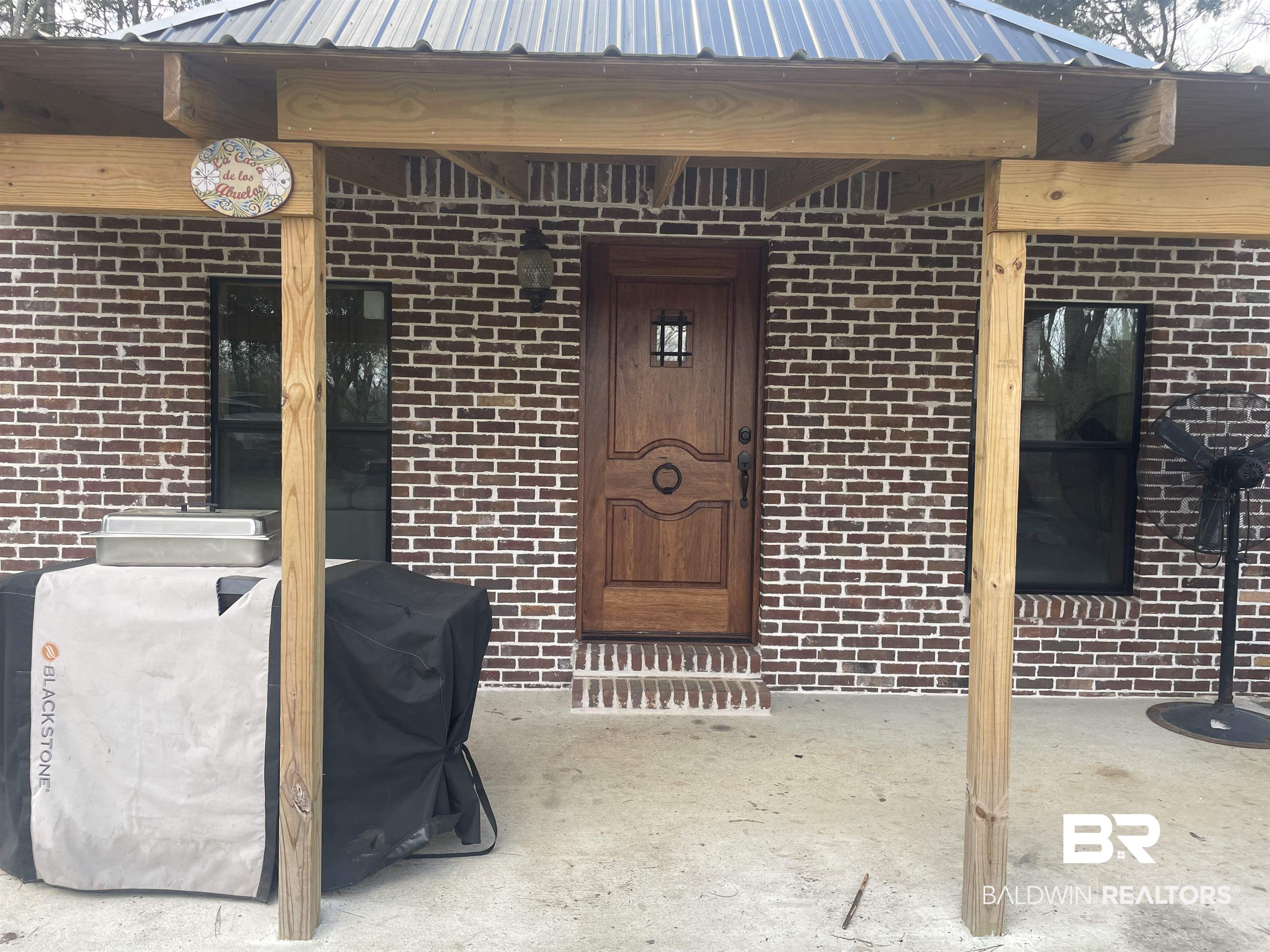 21593 Hubbard Road Robertsdale, AL 36567 - Photo 15 of 22 Doorway to property featuring brick siding and metal roof