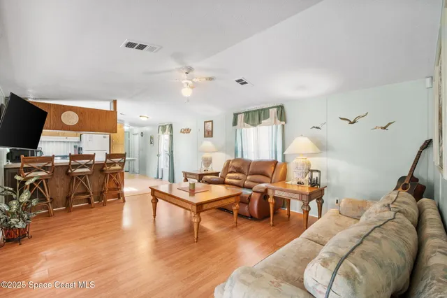 a kitchen with stainless steel appliances kitchen island granite countertop a refrigerator and a stove top oven