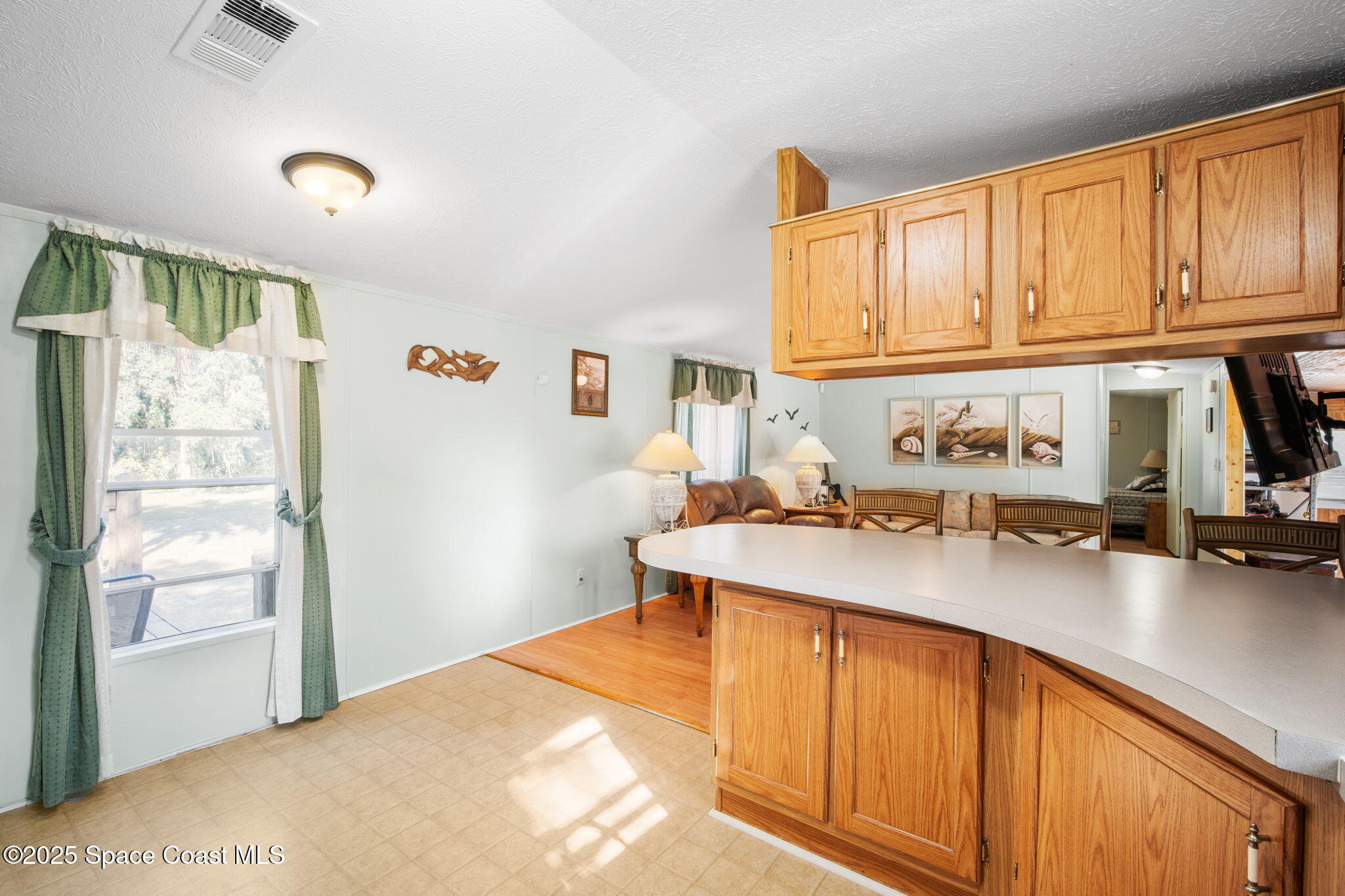 6672 Bear Trail Cocoa, FL 32926 - Photo 13 of 46 a kitchen with stainless steel appliances granite countertop a sink refrigerator and cabinets