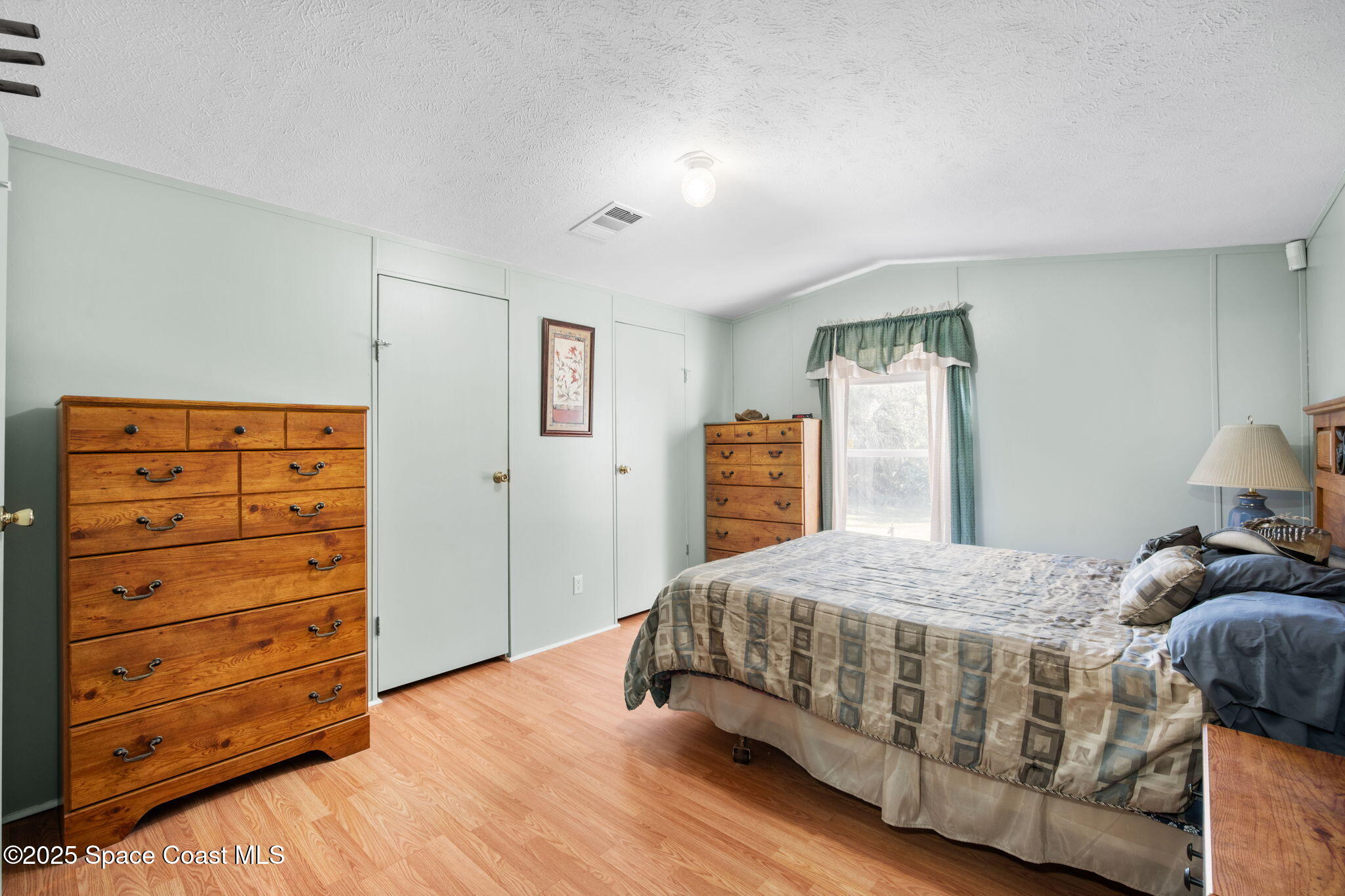 6672 Bear Trail Cocoa, FL 32926 - Photo 17 of 46 a bedroom with a bed and a dresser