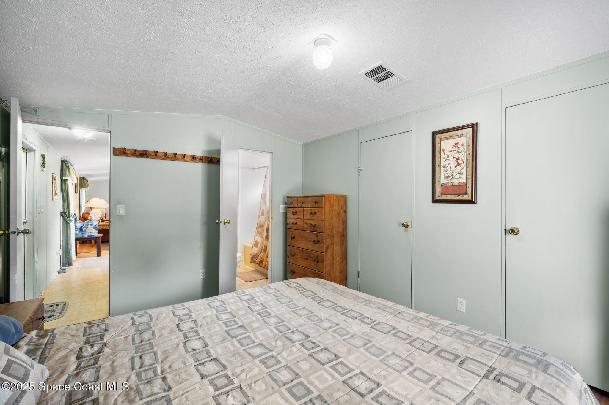 6672 Bear Trail Cocoa, FL 32926 - Photo 18 of 46 a bedroom with a bed and a dresser