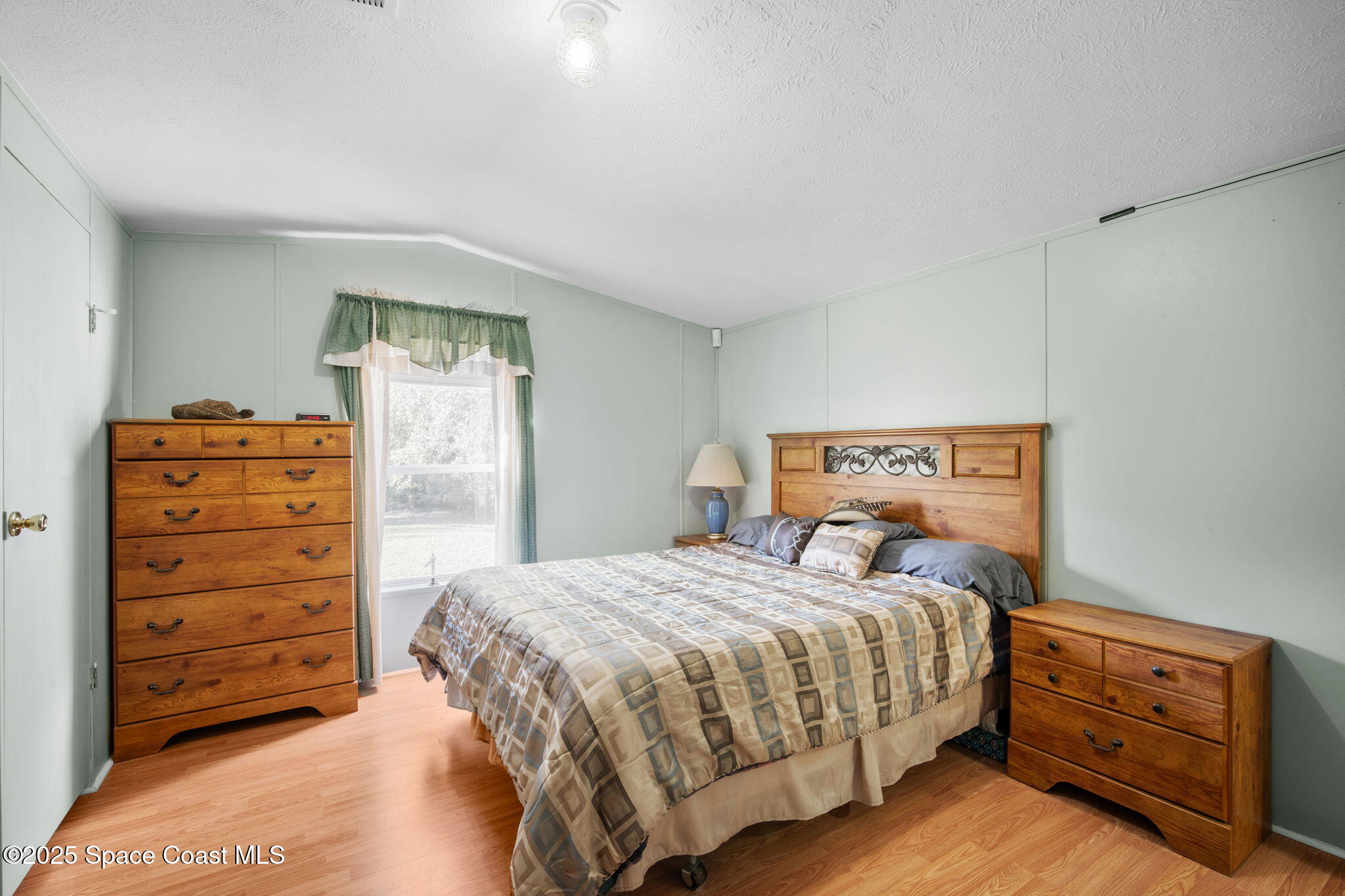 6672 Bear Trail Cocoa, FL 32926 - Photo 19 of 46 a bedroom with a bed and a dresser
