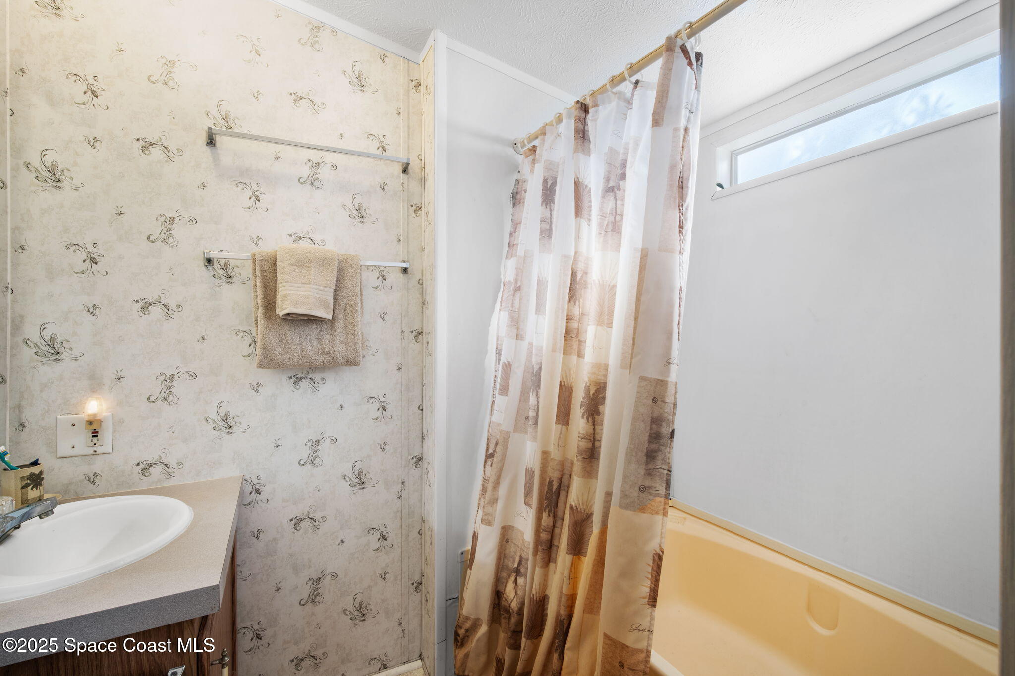 6672 Bear Trail Cocoa, FL 32926 - Photo 21 of 46 a bathroom with a shower curtain and a sink