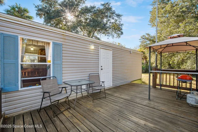 a view of a wooden deck with a yard