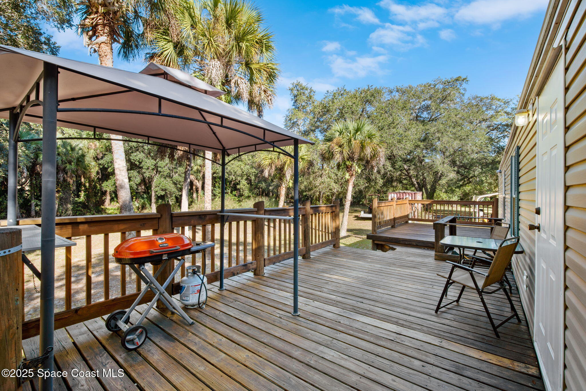 6672 Bear Trail Cocoa, FL 32926 - Photo 27 of 46 a view of chairs on wooden deck