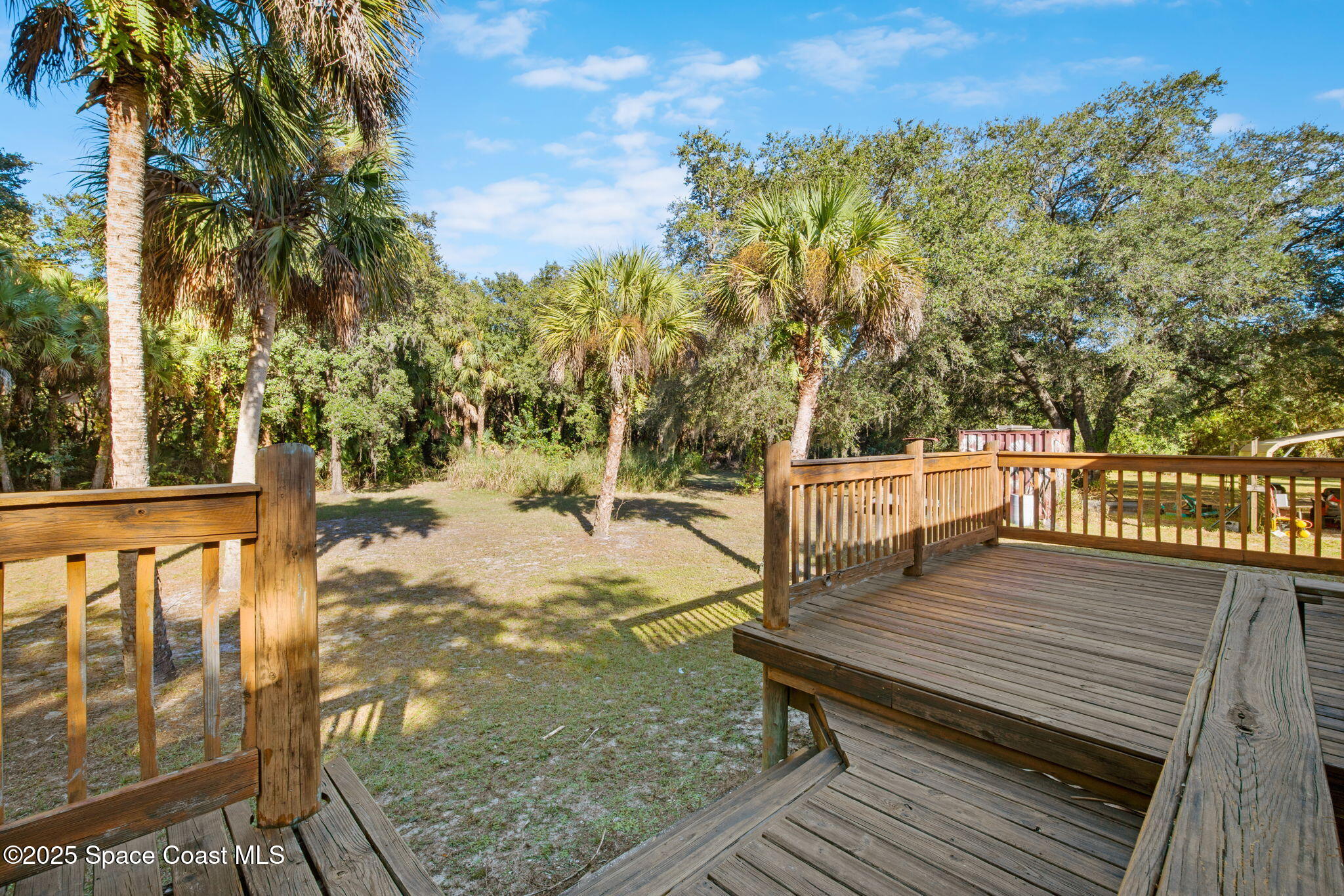 6672 Bear Trail Cocoa, FL 32926 - Photo 28 of 46 a view of a wooden deck with a yard